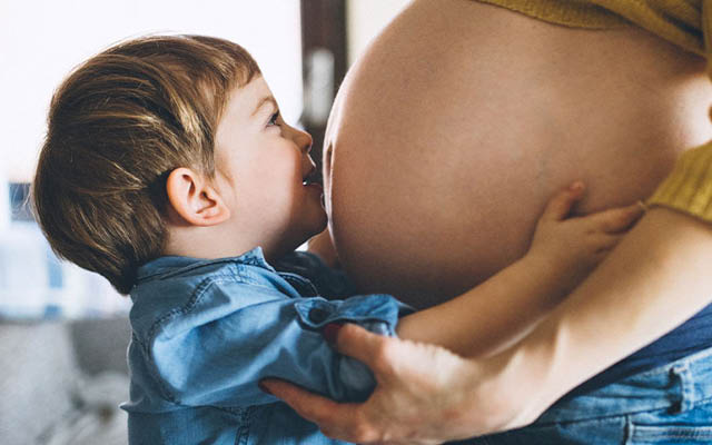 Gutt klemmer på gravid mage